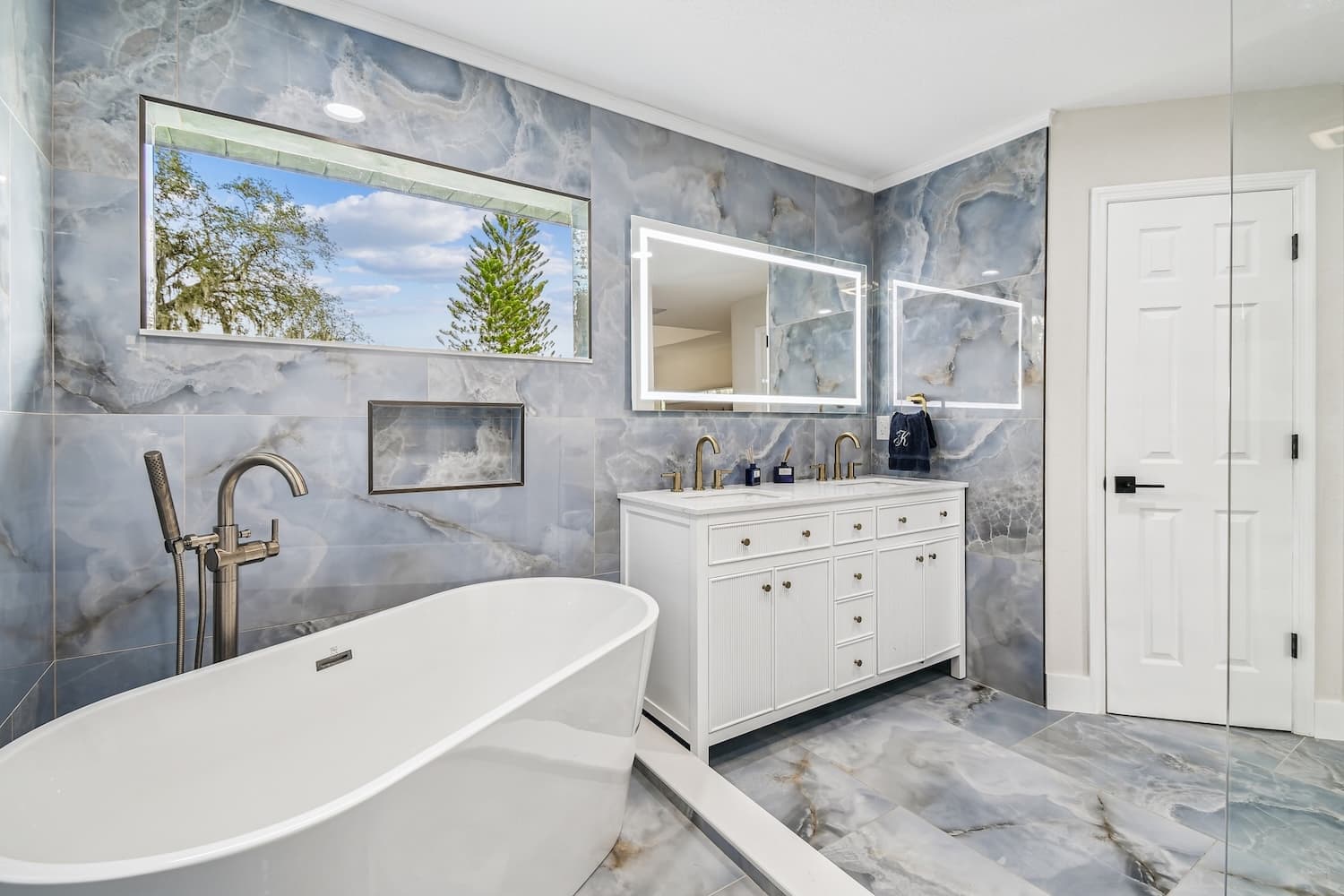 Blue marble bathroom with double vanity and LED mirror