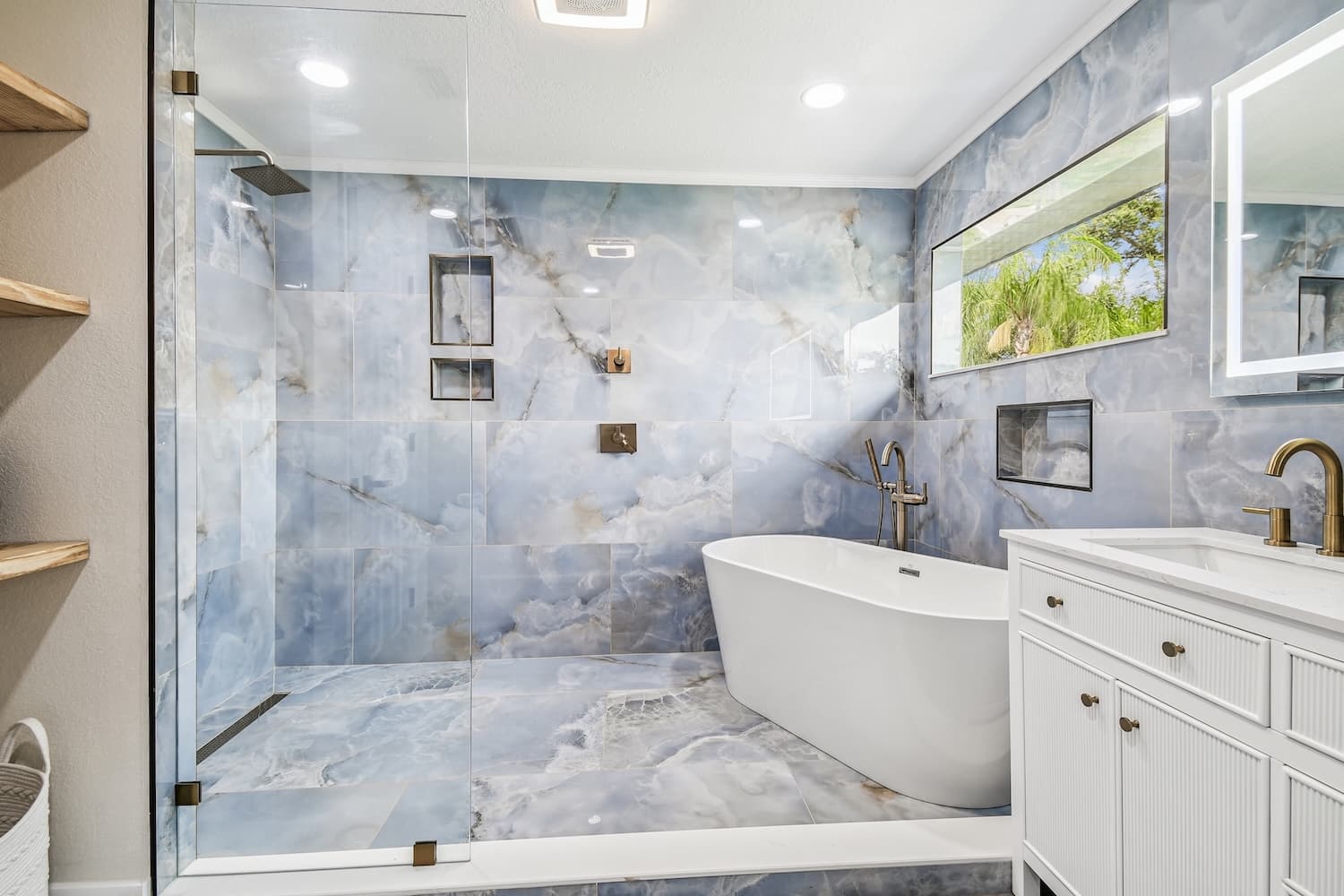 Modern Tampa bathroom renovation with blue marble and freestanding tub
