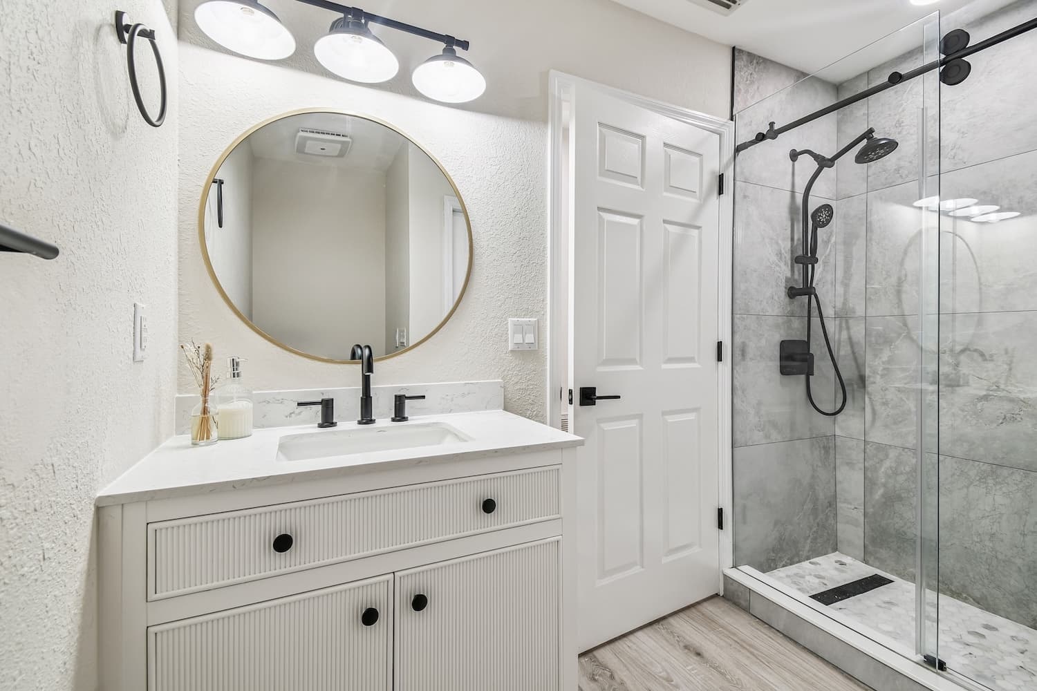 Bathroom renovation with white vanity and glass shower