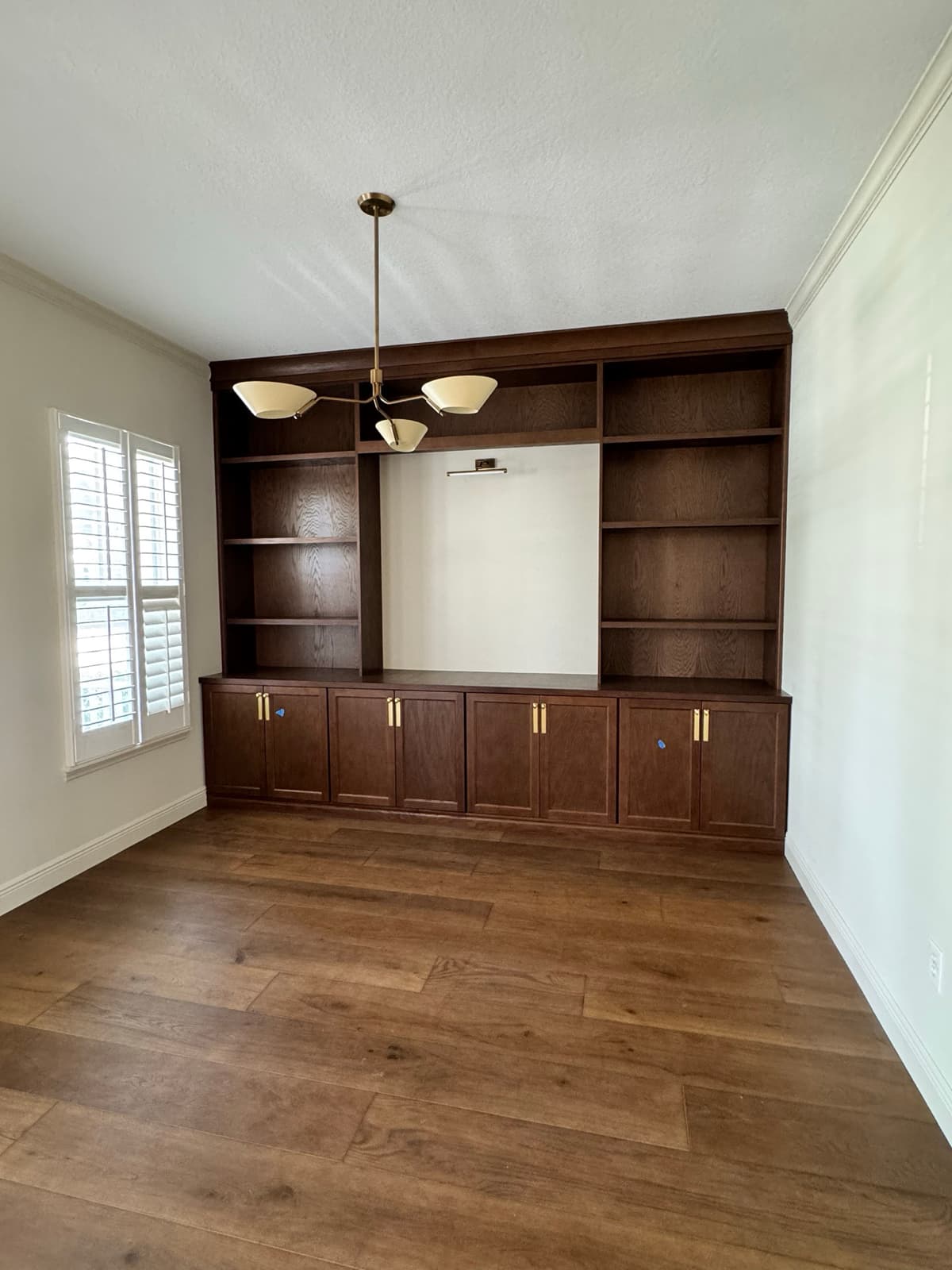Custom built-in entertainment center with dark wood cabinetry in Tampa