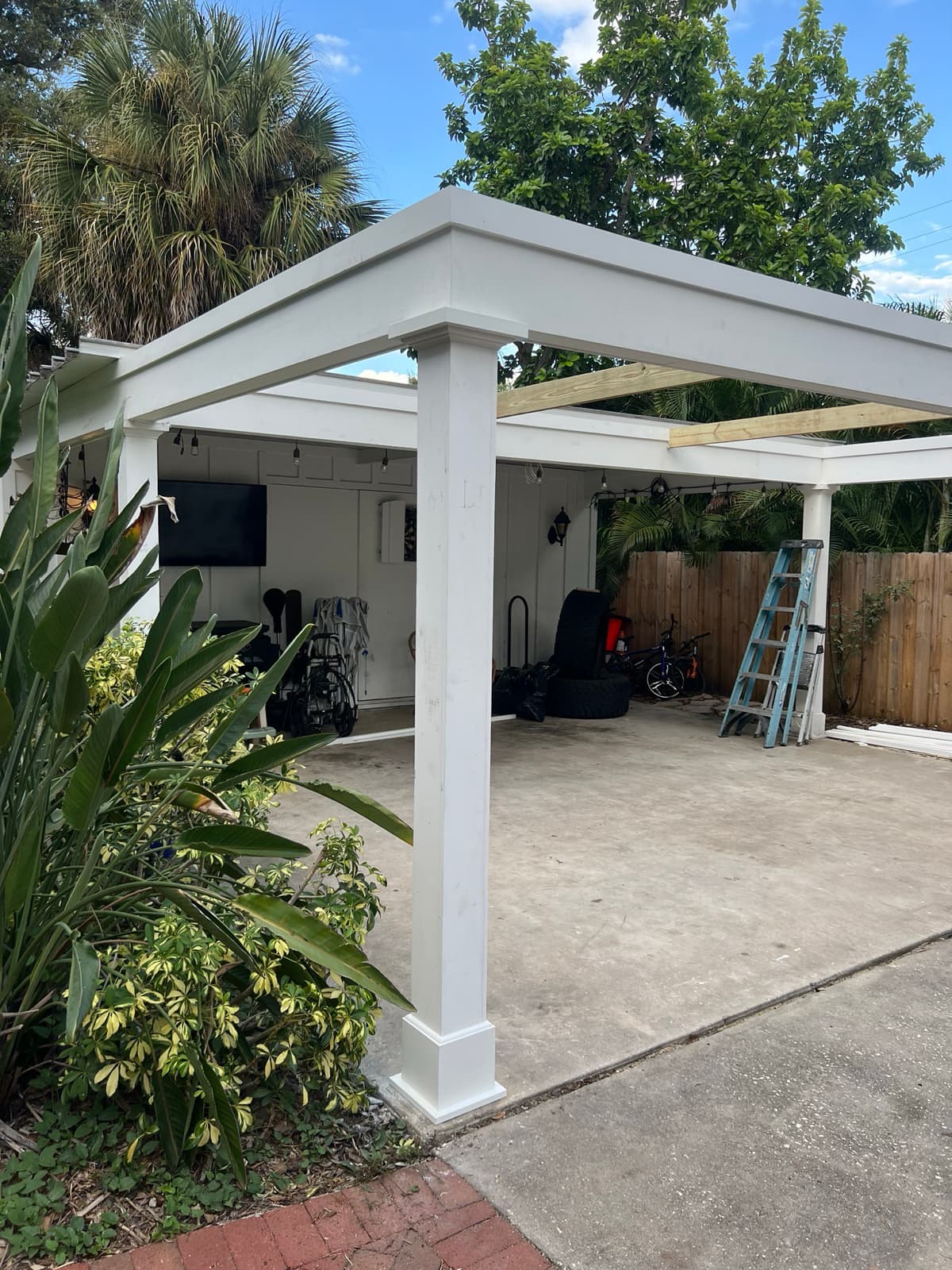 Completed carport renovation with white columns in Tampa